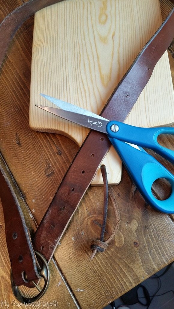cut thrift store leather belt to make leather handle for diy cutting board