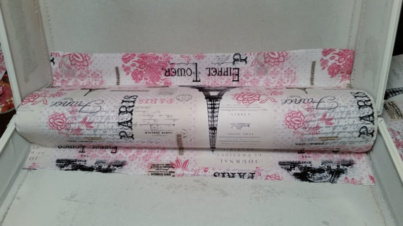 glue gun secures fabric and paper vintage suitcase lining makeover
