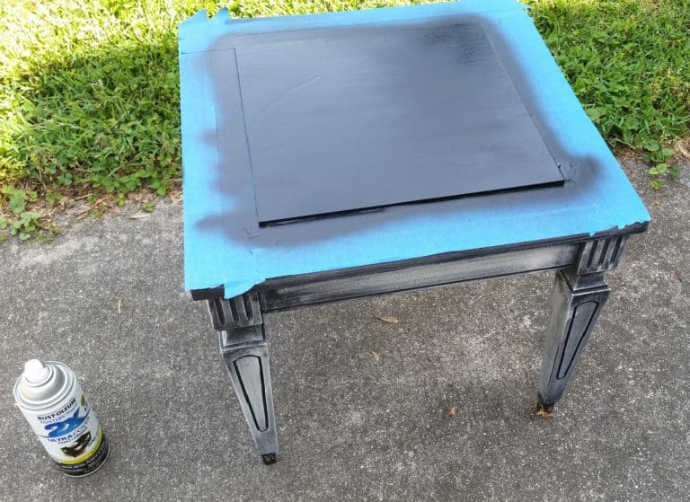 small table being spray painted black