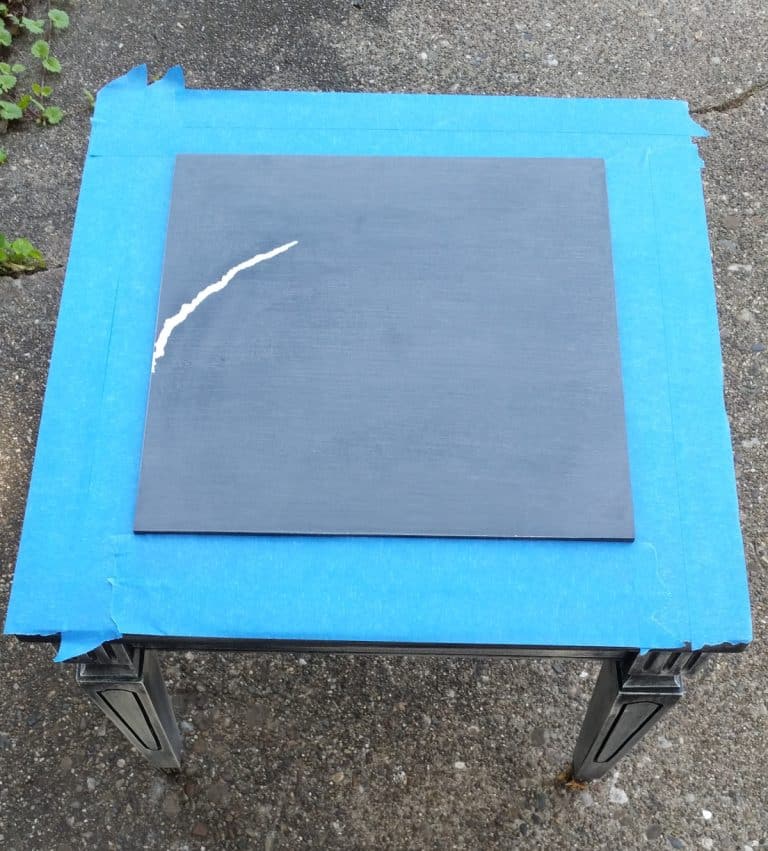 black top table with a big white scratch