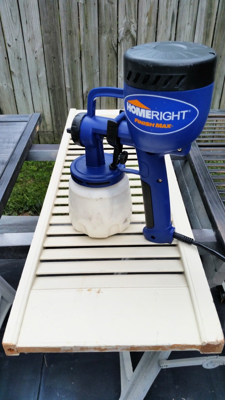 finish max paint sprayer resting on old shutter