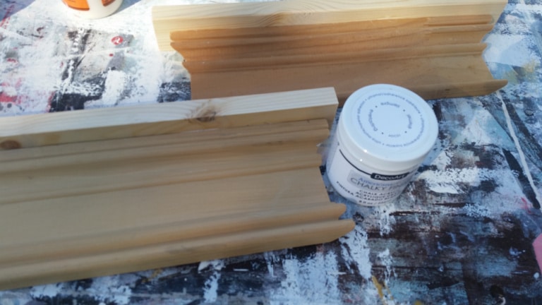 wood molding and a small jar of paint