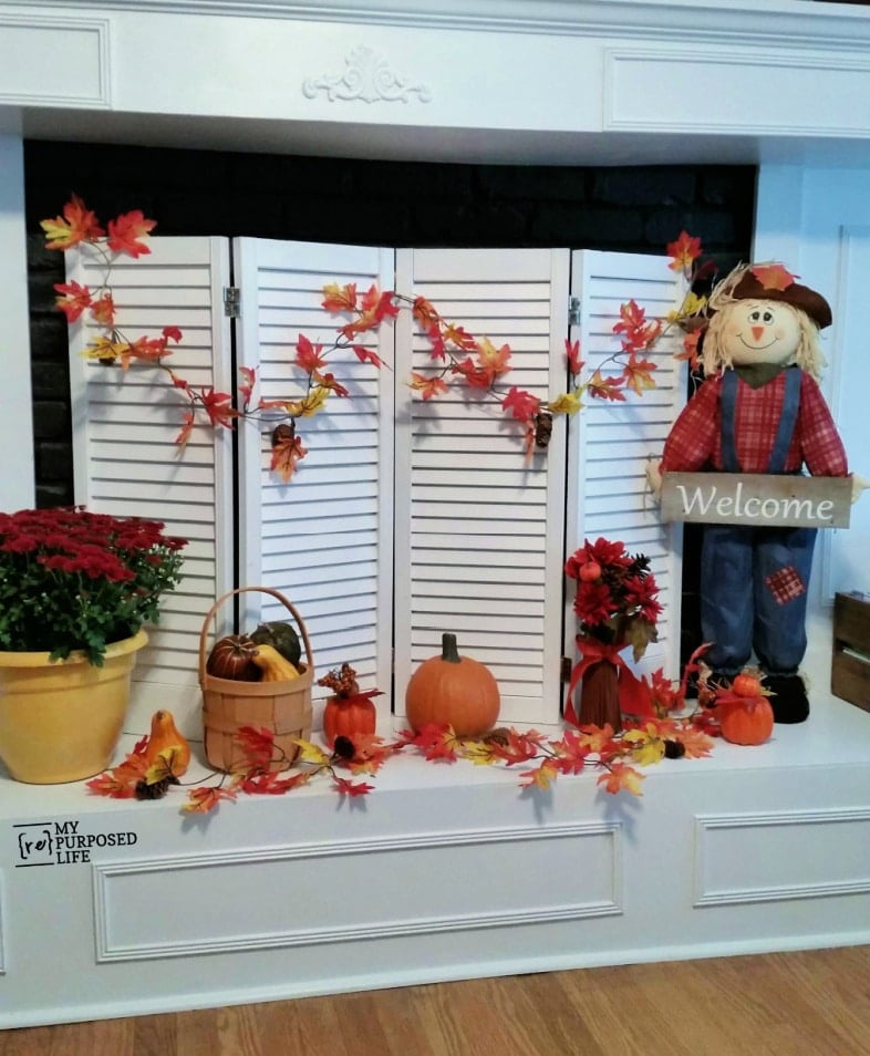 white upcycled shutter fireplace screen decorated for fall