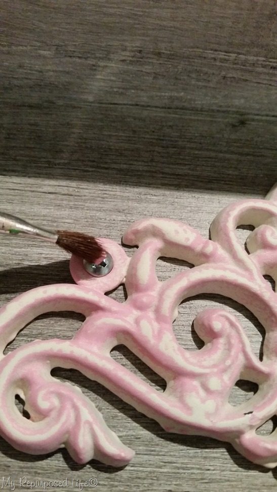 dab screw heads with pink paint