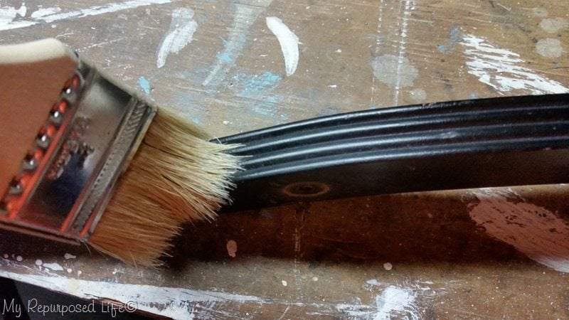 use paintbrush to dust grooves