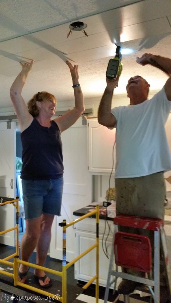 use scafold to install planks to cover up popcorn ceiling