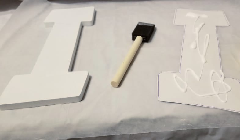 apply mod podge to paper with foam brush