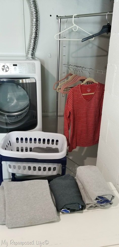 refreshed basement laundry space with painted garment rack