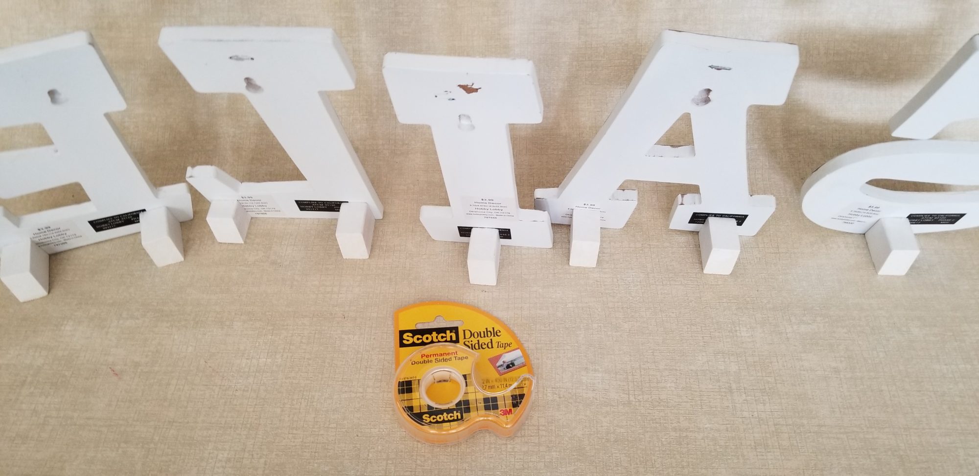 apply double stick tape to easels for temporary display