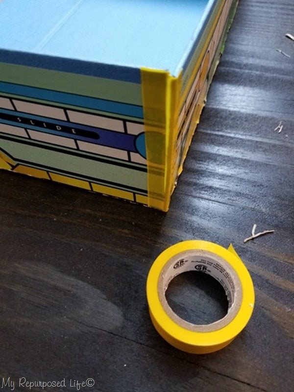 cut electrical tape to size to assemble game board box