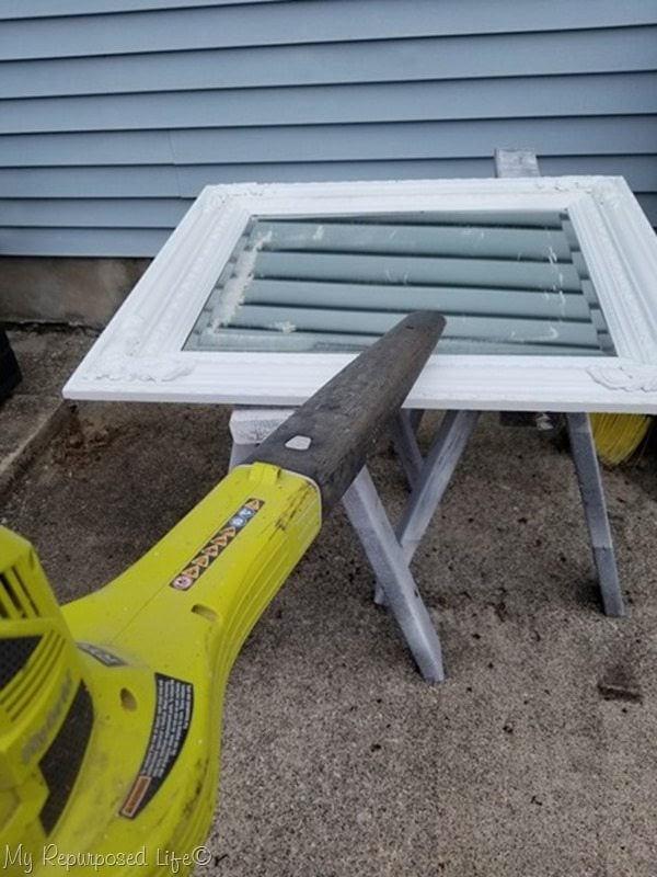 leaf blower removes paint dust after scraping