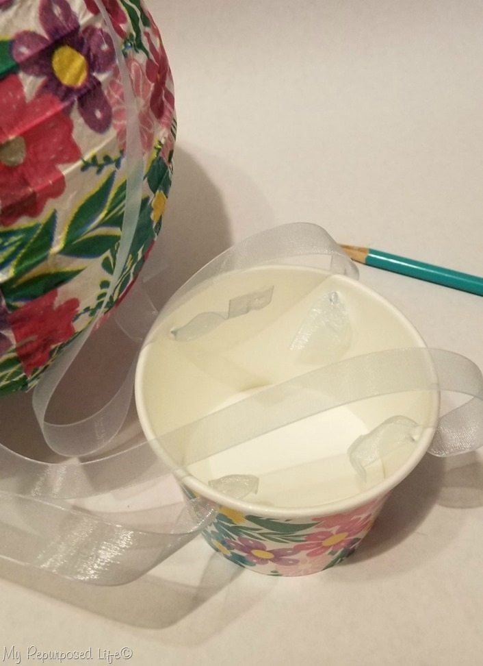 use pencil point to push ribbon through cardboard candy cup