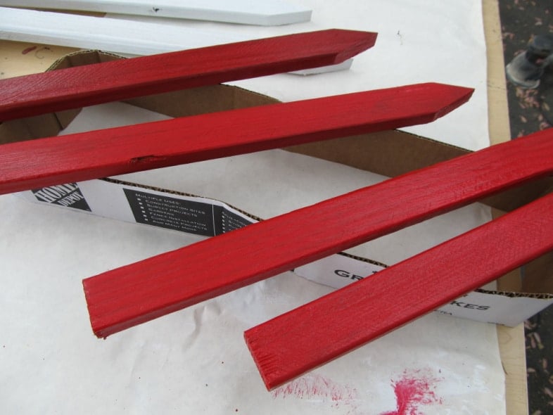 red wooden garden stakes