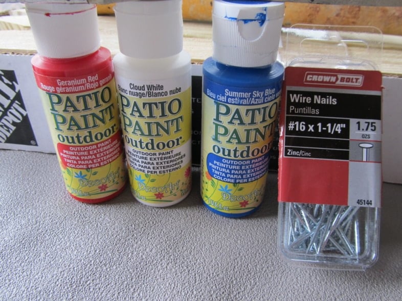 small bottles of paint and some brad nails