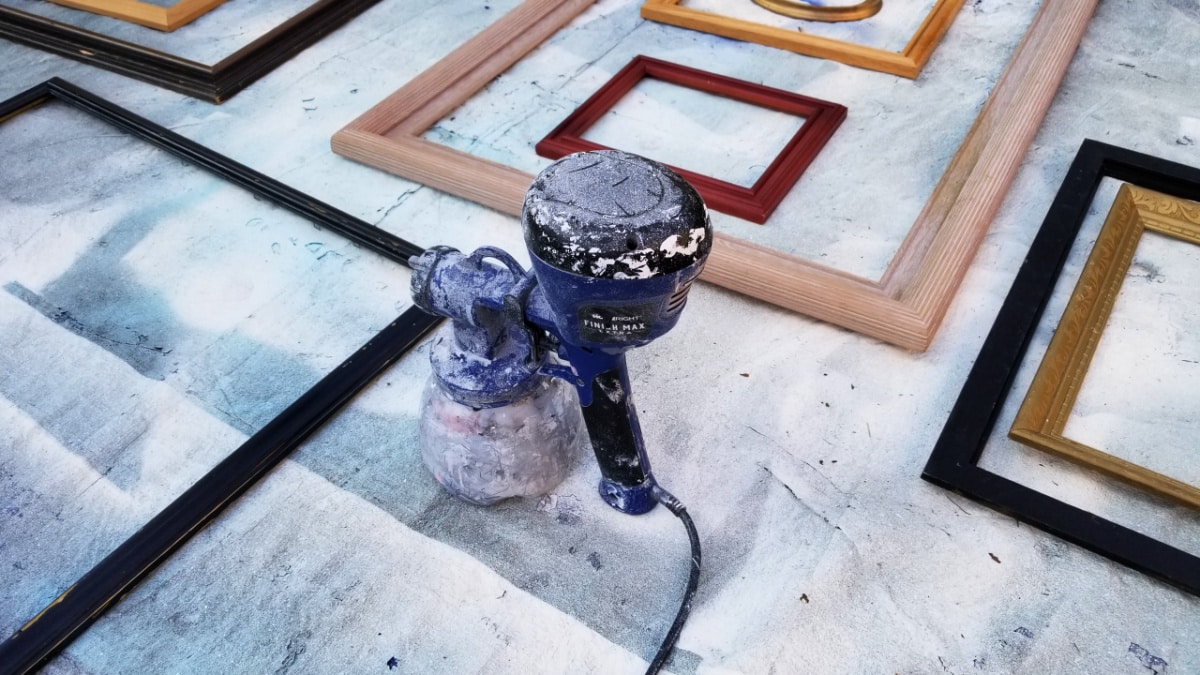 painting random picture frames with a paint sprayer