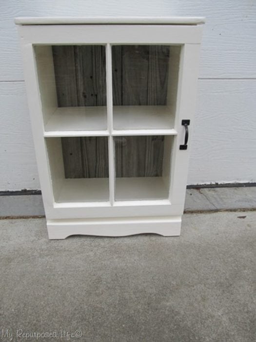 repurposed or upcycled nightstand made using a vintage window as a door