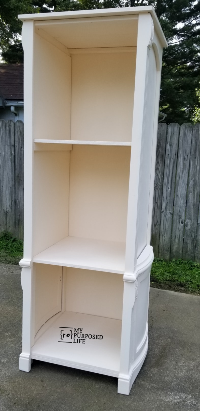 finished white book shelf outside on a driveway