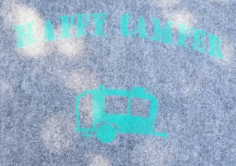 happy camper stencil on a rug
