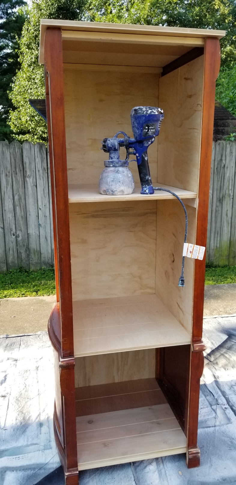 Finish Max paint sprayer resting on shelf of completed bookcase