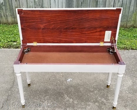 white piano bench with lid open