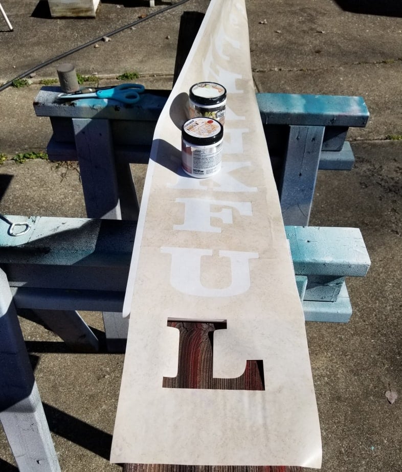 apply contact paper stencil to long board for thankful sign