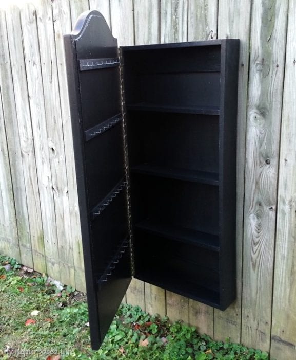 black jewelry wall cabinet made from a thrift store mirror