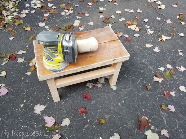 orbital sander smooths rough corners on oversized stepstool