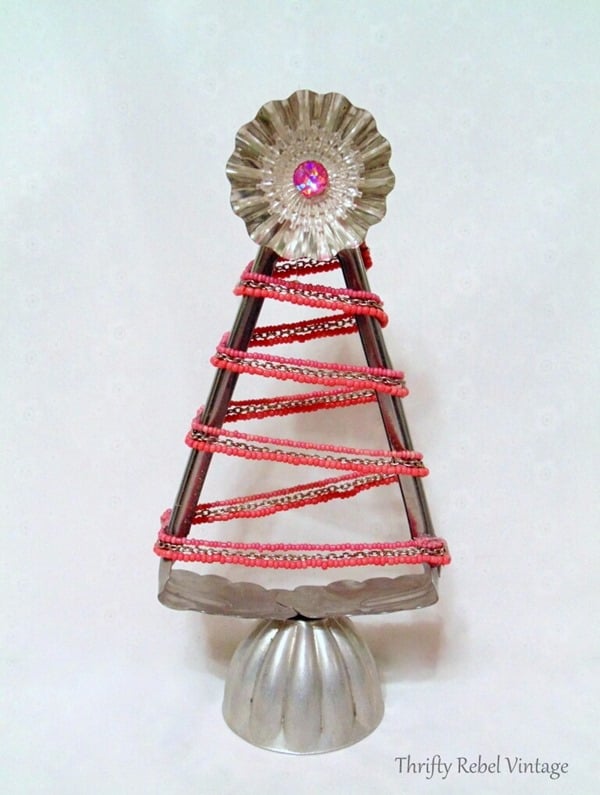 Repurposed-salad-tongs-into-Christmas-tree-with-pink-beaded-necklace-tart-tin-jello-mold-and-light-reflector.