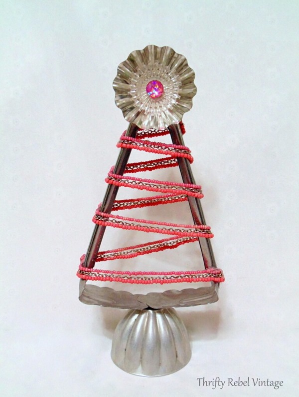 Repurposed-salad-tongs-into-Christmas-tree-with-pink-beaded-necklace-tart-tin-jello-mold-and-light-reflector. Repurposed-salad-tongs-into-Christmas-tree-with-pink-beaded-necklace-tart-tin-jello-mold-and-light-reflector.