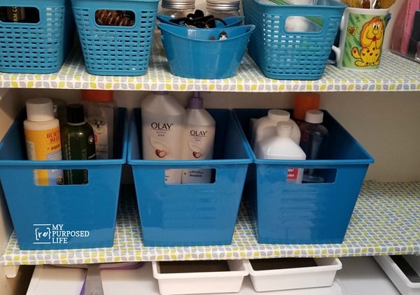 baskets and bins organized toiletries in the linen closet MyRepurposedLife
