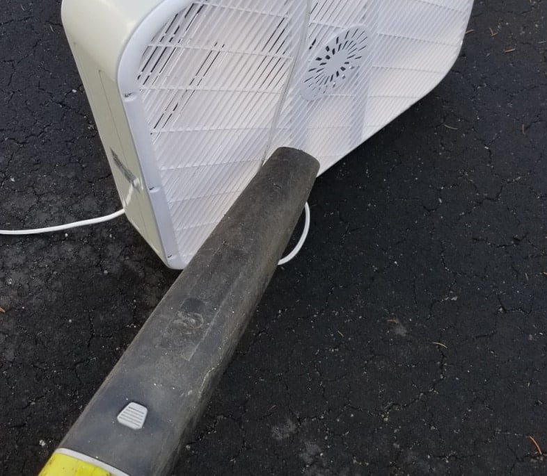 leaf blower cleaning a fan