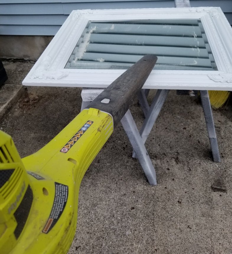leaf blower removes paint dust after scraping
