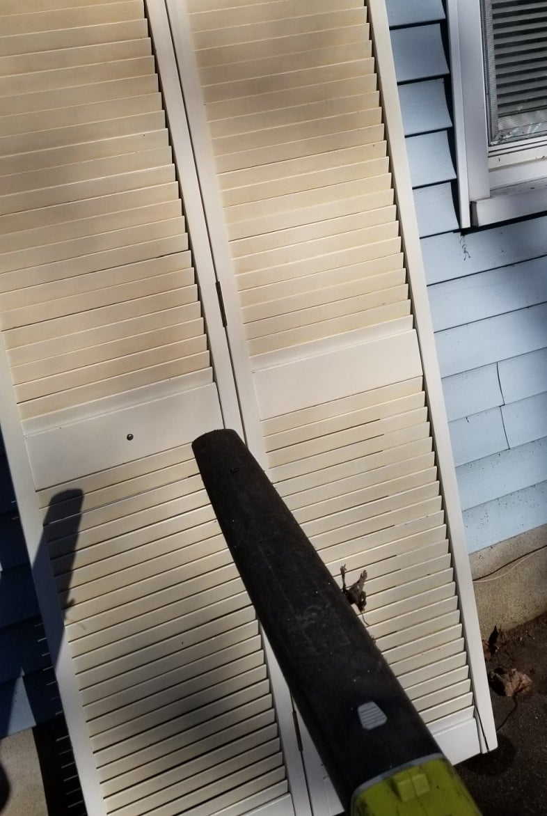 leaf blower drying off louvered doors