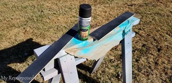 spray chalkboard paint on plywood strips