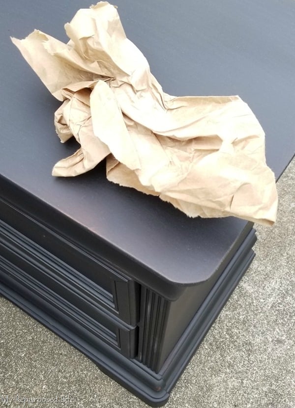 use packing paper to sand smooth vintage black nightstands