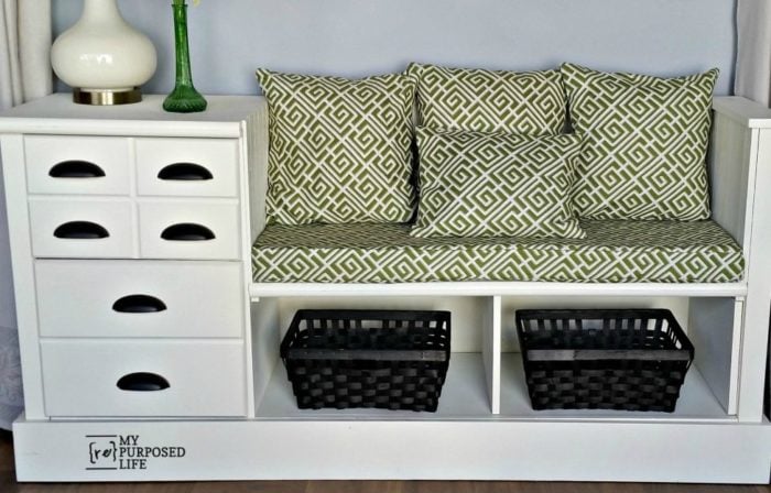 white storage bench with green cushions