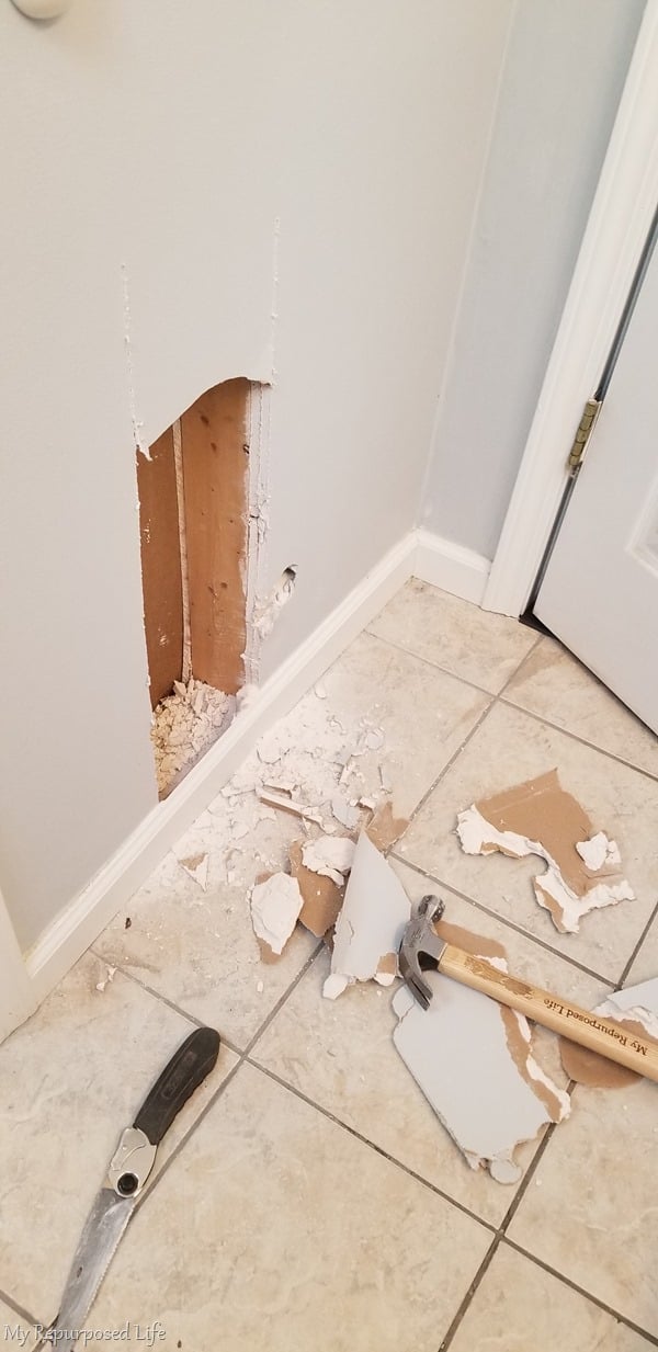 impatient diy blogger knocks a hole in the wall for between the studs storage