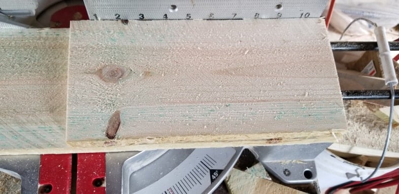 boards resting on miter saw