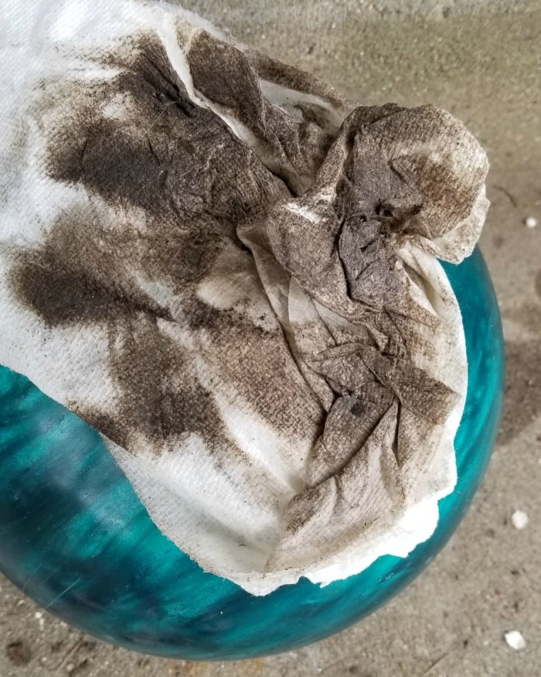dirty paper towel resting on an aqua bowling ball