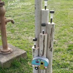 how to make a lighting feature using dollar store solar lights and landscape timbers MyRepurposedLife