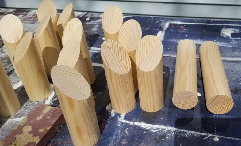 a bunch of wooden dowels cut for molkky game