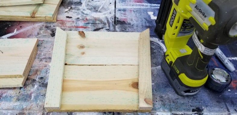 green ryobi nail gun and small wood section