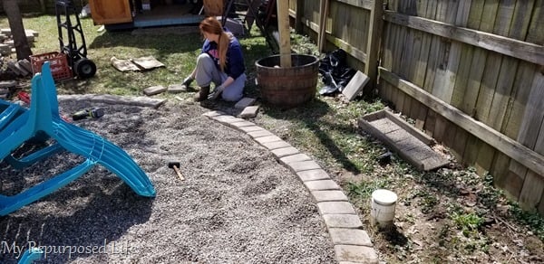 one paver at a time around the fire pit