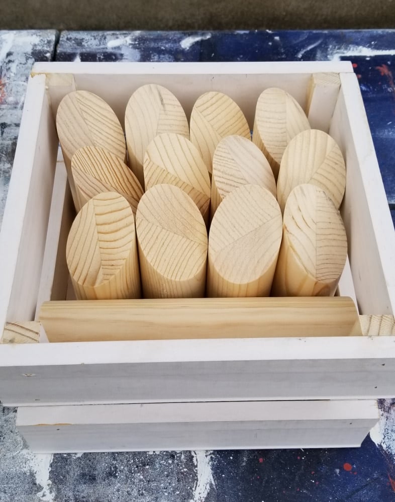 dowel rod pieces in the crate