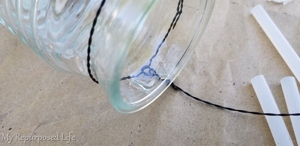 a dab of hot glue holds solar light in place