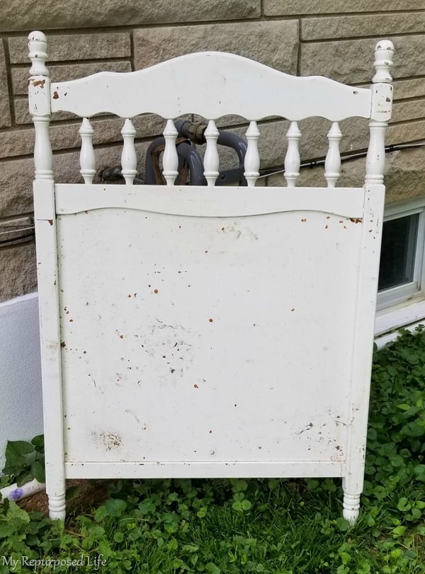 vintage crib repurposed as a faux garden gate gas meter cover