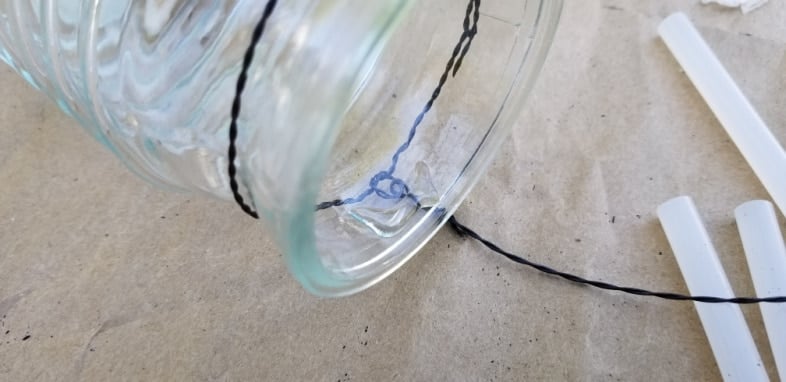 a dab of hot glue holds solar light in place