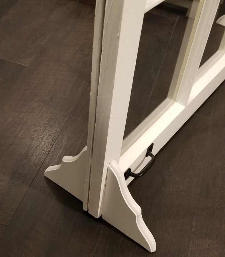 wooden brackets support the window fireplace screen