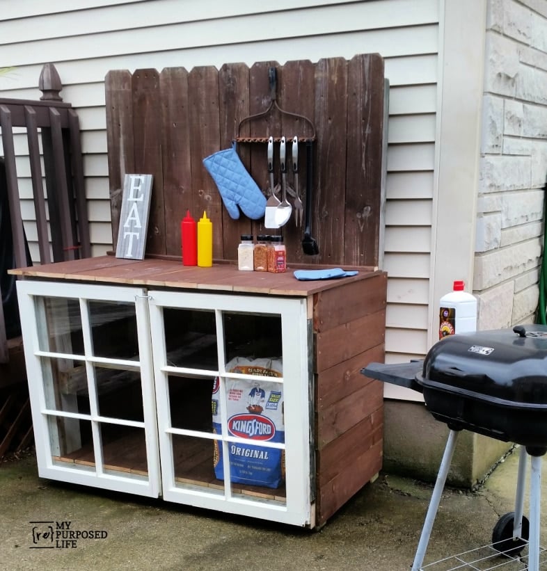 outdoor grill station with white window doors ready for a cookout