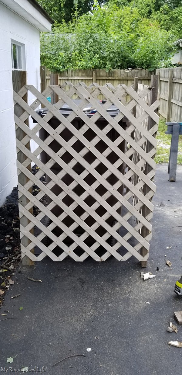 side view of garbage can enclosure made of lattice